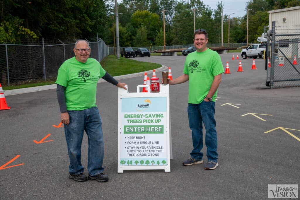Board Chairperson Perry Beachum and General Manager Charlie West welcome Lowell Light and Power customers to the Energy Savings Trees pick up at the Energy Center